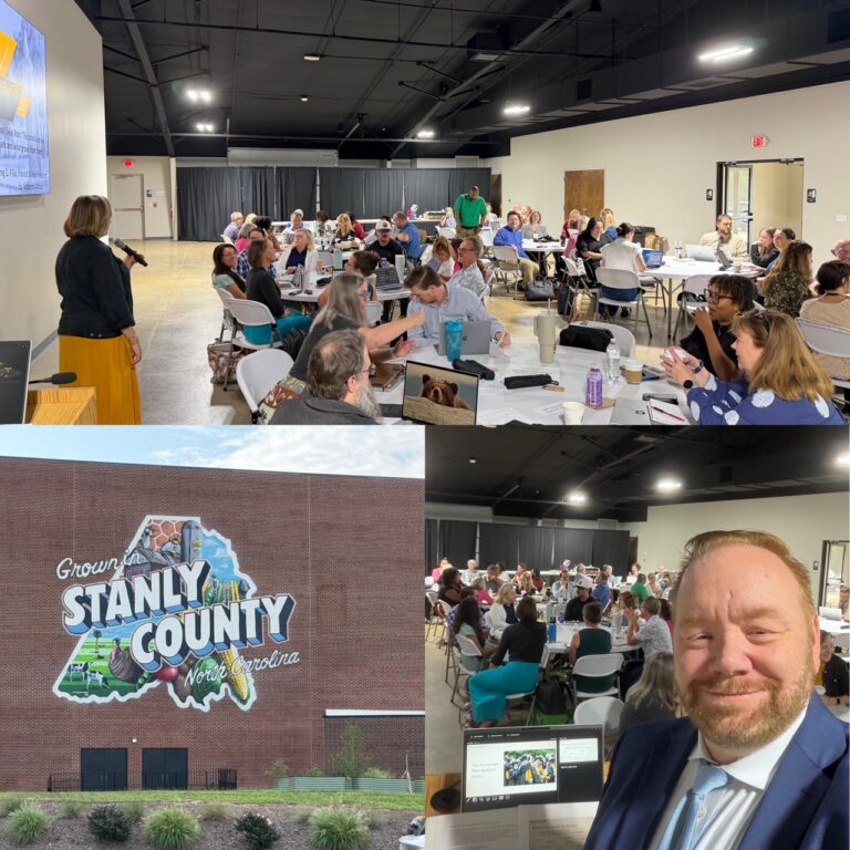 A community event in Stanly County, NC shows people seated at tables, a woman speaking, a mural on a brick wall, and a smiling man holding up a presentation slide.